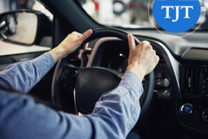 Driver holding steering wheel while driving through Bergen County, NJ