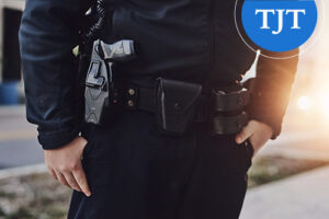 Close-up of a police officer's duty belt with holstered firearm and equipment