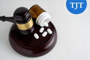 Judge's gavel beside an open pill bottle, illustrating drug possession offenses eligible for expungement under N.J.S.A. 2C:52-5 in New Jersey