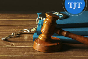 Wooden gavel and handcuffs on blue law books, representing criminal record expungement in New Jersey